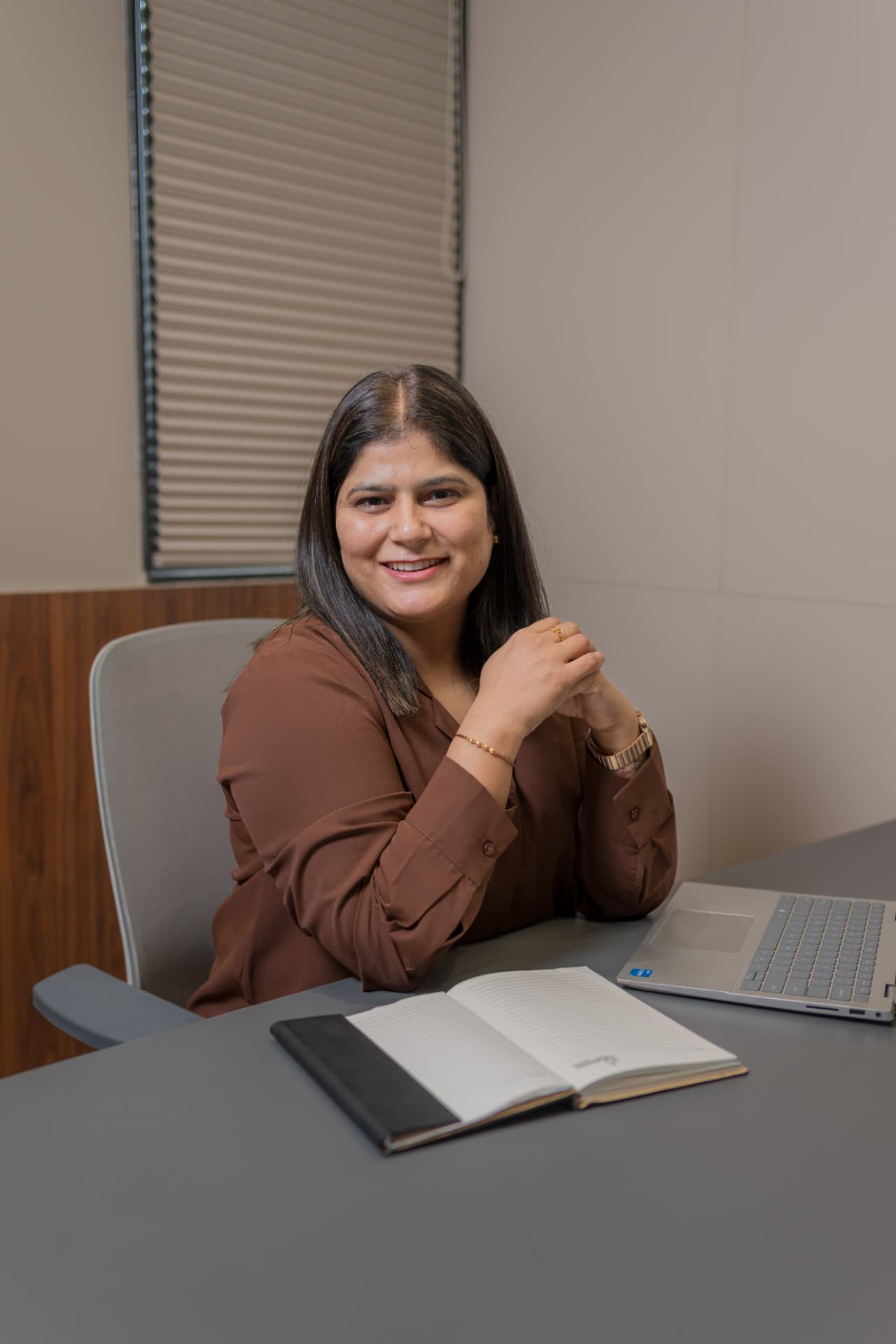 Coach Dipti at her desk